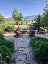 View of patio with a fire pit and a mountain view