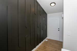 Hall with light wood finished floors and baseboards