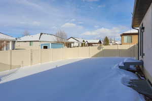 Fenced backyard with a residential view and a gate