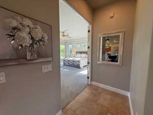 Corridor with light carpet and baseboards