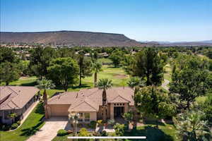 View from above of property with a mountainous background and a local golf course