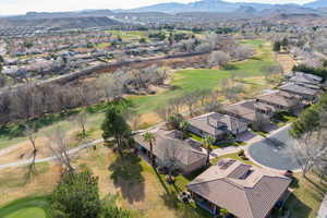 Aerial view of residential area with a golf course and mountains