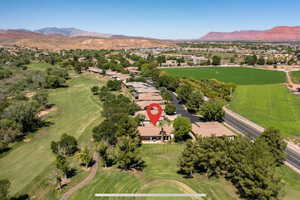 Aerial view of residential area with a mountainous background and a golf club