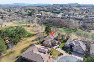 Aerial perspective of suburban area with a local golf course and a mountain backdrop