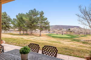 View of patio featuring a mountain view and golf course view