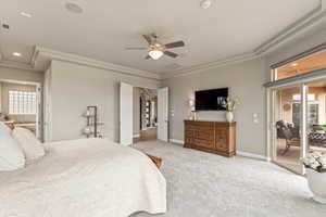 Carpeted bedroom with access to exterior, a ceiling fan, arched walkways, and recessed lighting
