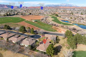 Aerial overview of property's location featuring nearby suburban area, a water and mountain view, and a local golf course