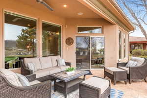 View of patio featuring an outdoor hangout area and a ceiling fan
