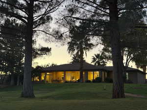 Rear view of property featuring a yard and a patio area