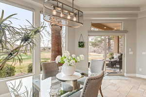 Dining area featuring baseboards and light stone finish flooring