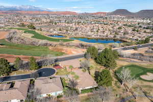 Aerial view of residential area featuring a golf course and a water and mountain view