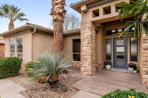 Entrance to property featuring stucco siding