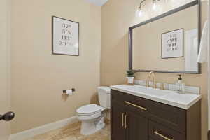 Half bath with vanity and toilet