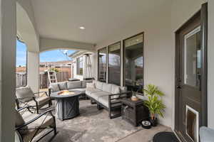 View of patio with an outdoor living space with a fire pit