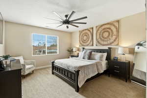 Carpeted bedroom with baseboards and ceiling fan