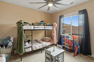 Bedroom featuring light carpet and a ceiling fan