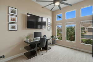 Office space featuring light colored carpet, a high ceiling, and a ceiling fan