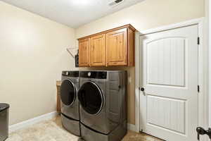 Laundry area with washing machine and dryer and cabinet space