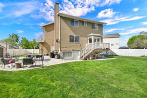 Rear view of house with a patio area, a fenced backyard, and a chimney