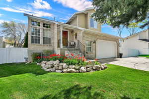 View of front of home featuring brick siding, driveway, and an attached garage
