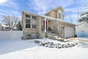 View of front of home with brick siding and an attached garage