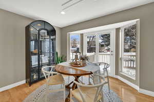 Dining area featuring light wood-type flooring, a textured ceiling, and recessed lighting