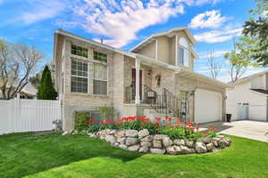 Traditional-style home with driveway and brick siding