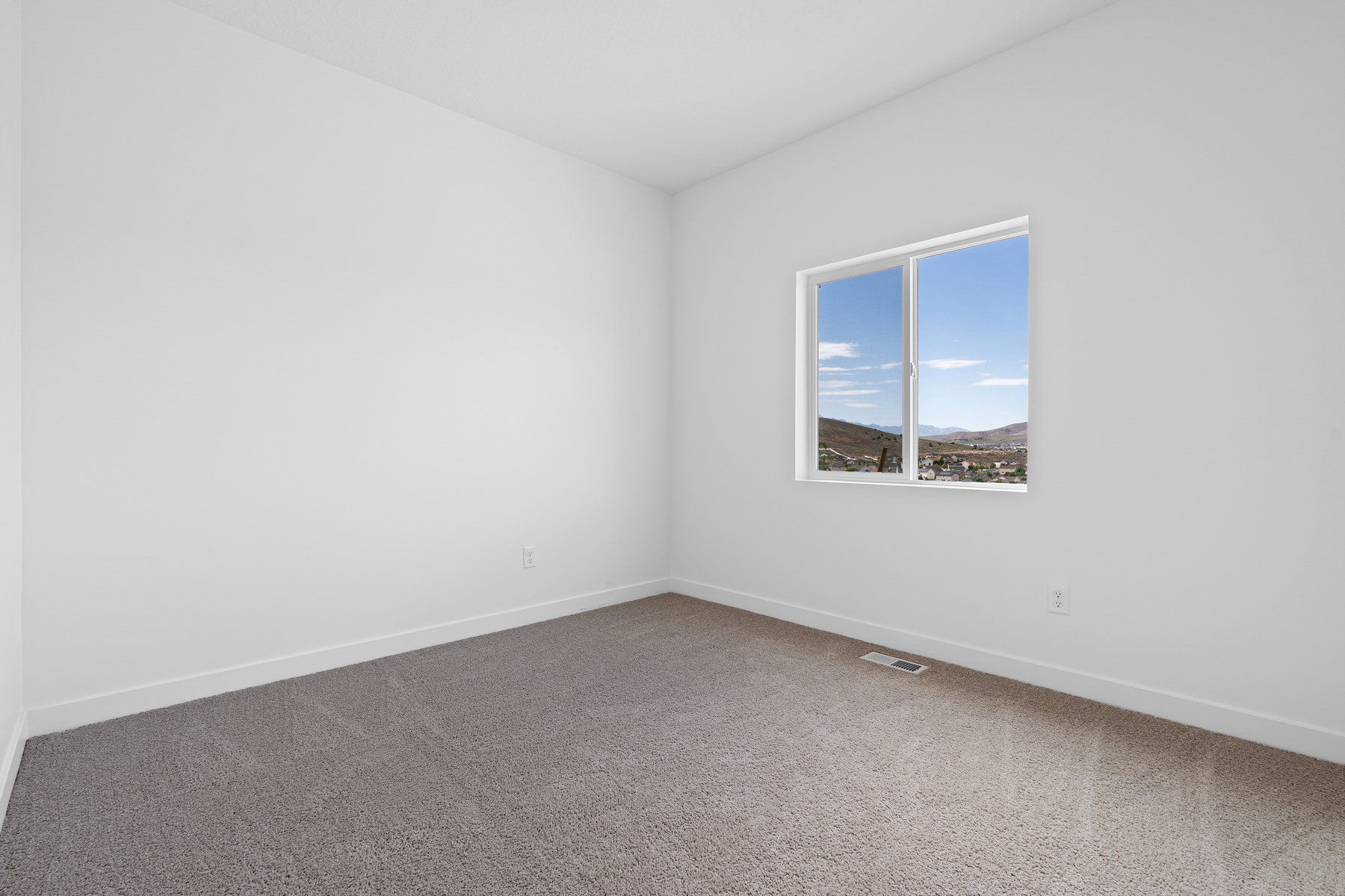 Unfurnished room featuring dark colored carpet and baseboards