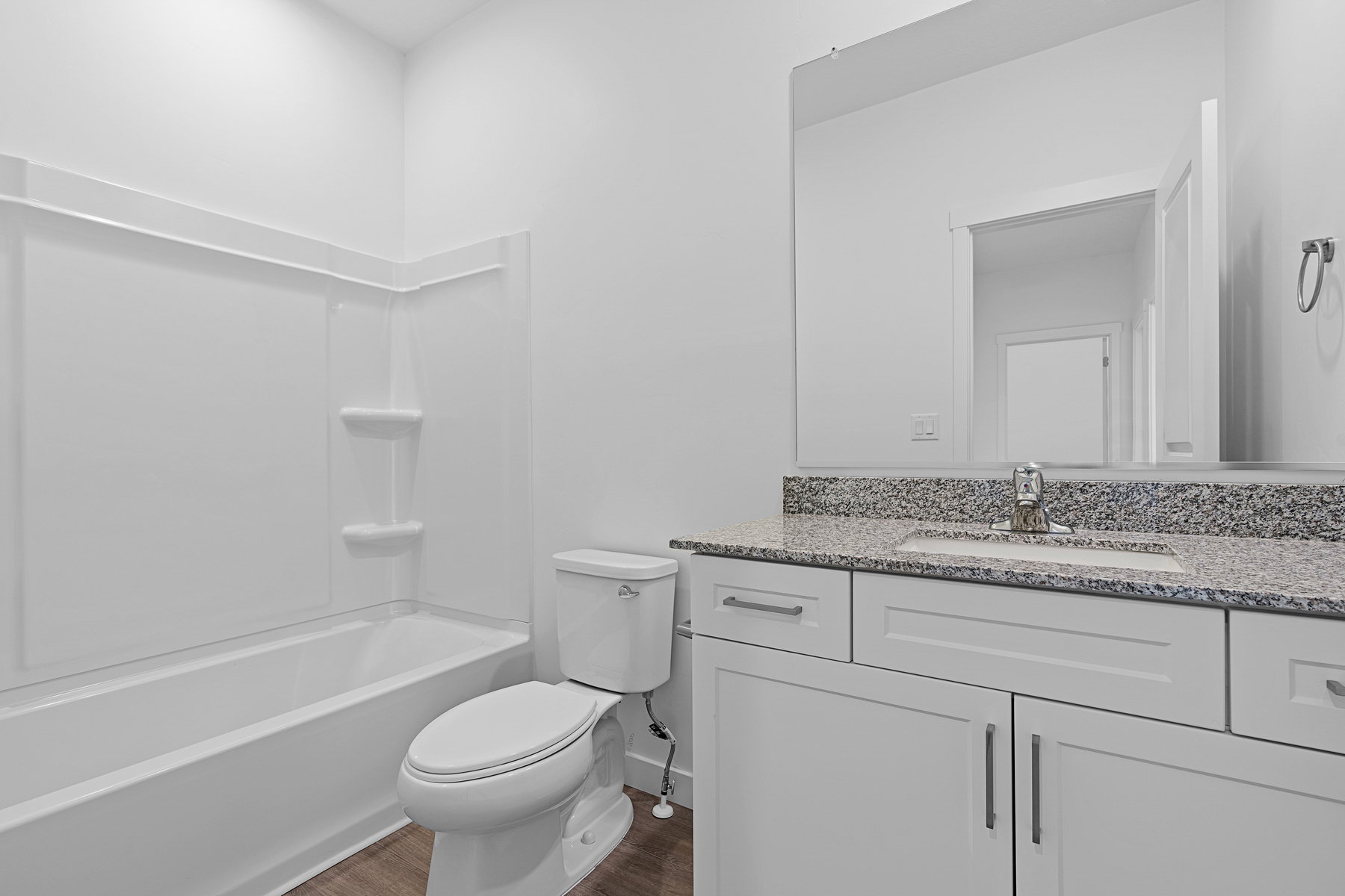 Full bath featuring vanity, dark wood finished floors, and tub / shower combination