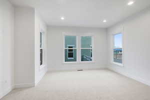 Unfurnished room featuring light carpet and recessed lighting