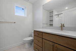 Full bath featuring vanity, a shower, and light tile patterned floors