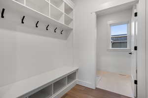 Mudroom featuring wood finished floors and baseboards