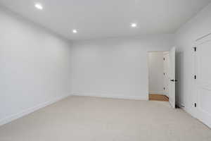 Spare room with light carpet and recessed lighting
