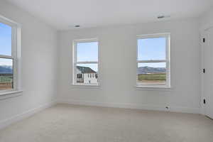 Spare room featuring light carpet and a mountain view