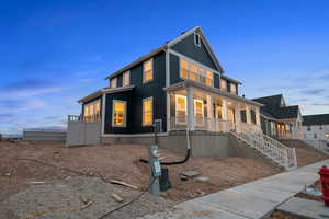 View of front facade with covered porch and stairway