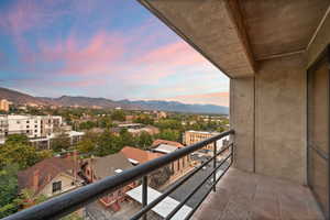 Balcony at dusk featuring a mountain view