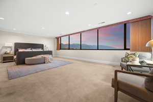 Bedroom featuring a mountain view, light colored carpet, recessed lighting, and ornamental molding