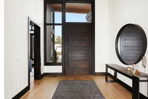 Entrance foyer with light wood-style floors and baseboards