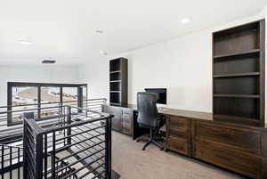 Bedroom with light carpet, a desk, and recessed lighting