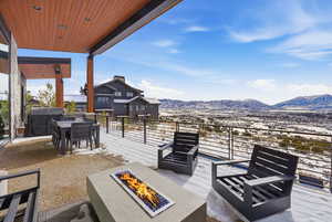 View of patio / terrace with a grill, a mountain view, and an outdoor fire pit