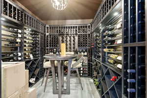 Wine room featuring suspended lighting