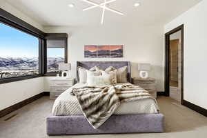 Bedroom with carpet floors, ensuite bathroom, a mountain view, a ceiling fan, and recessed lighting