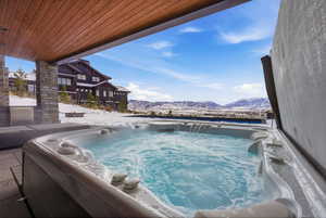 View of pool featuring a hot tub and a mountain view