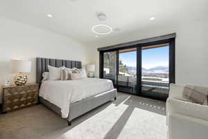 Carpeted bedroom with a mountain view and recessed lighting