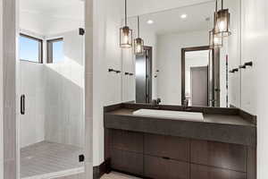Full bath featuring a shower stall, vanity, and recessed lighting