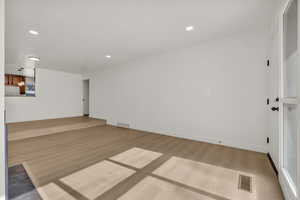 Unfurnished living room with light wood-style flooring and recessed lighting