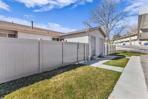 View of property exterior with stucco siding and a gate