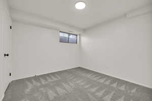Spare room featuring baseboards and carpet