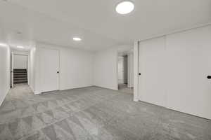 Finished basement featuring light carpet and recessed lighting