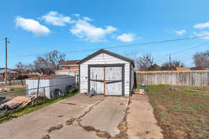 View of shed with a fenced backyard